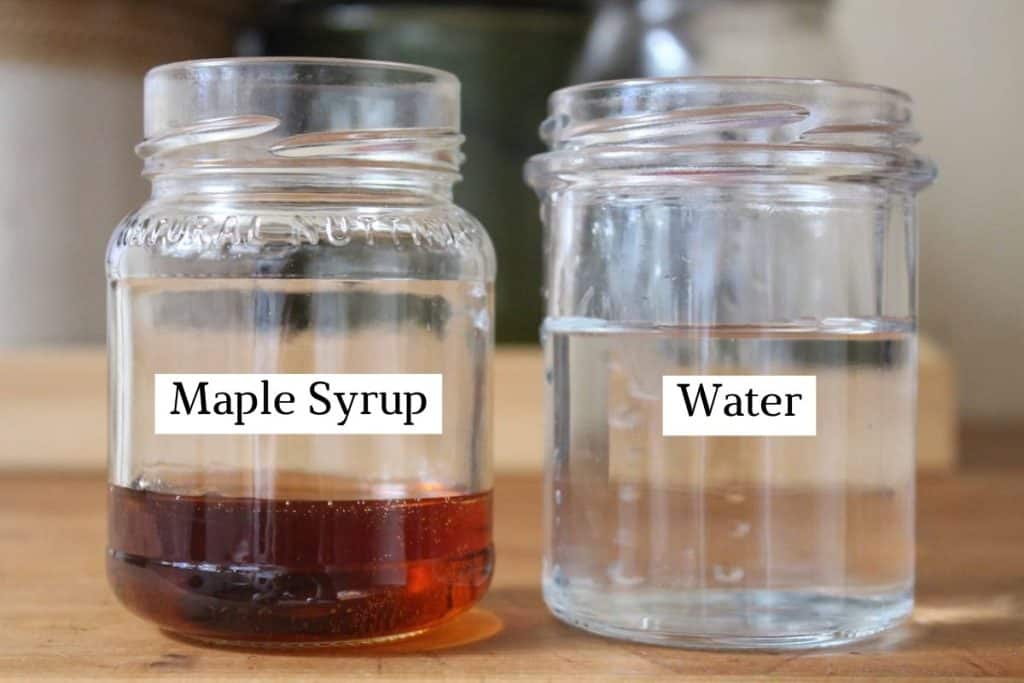 Two small glass jars: one with maple syrup and one with water.